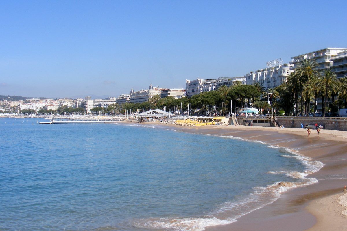 La Croisette beach in Cannes, with turquoise water and the grand seafront hotels