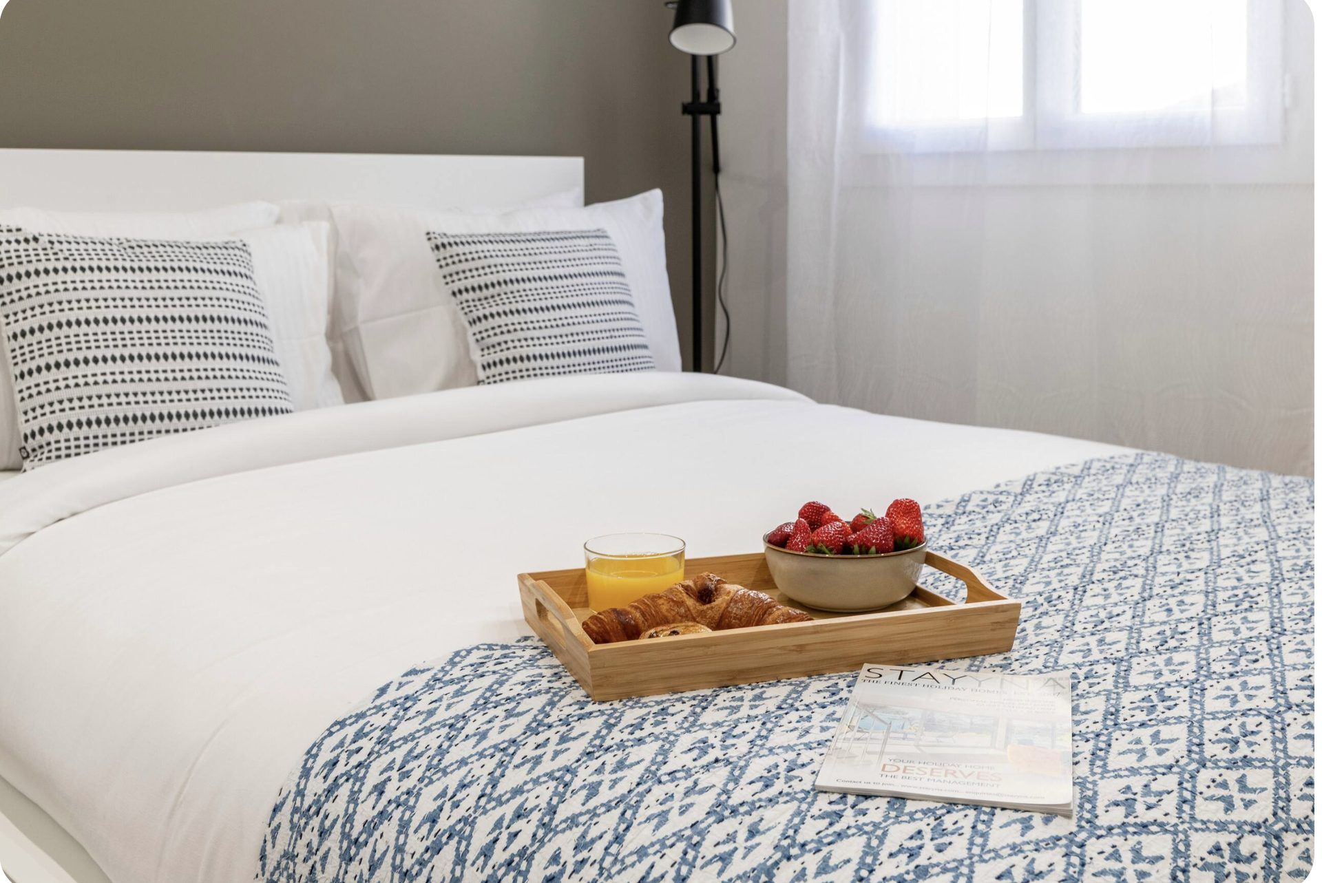 Breakfast tray with croissants and strawberries on the bed at Gilli