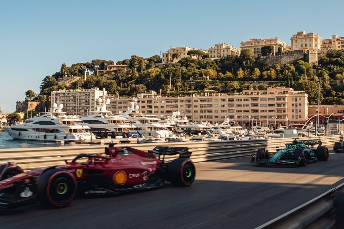 Formula 1 cars racing the Monaco harbour circuit past moored superyachts on a sunny day