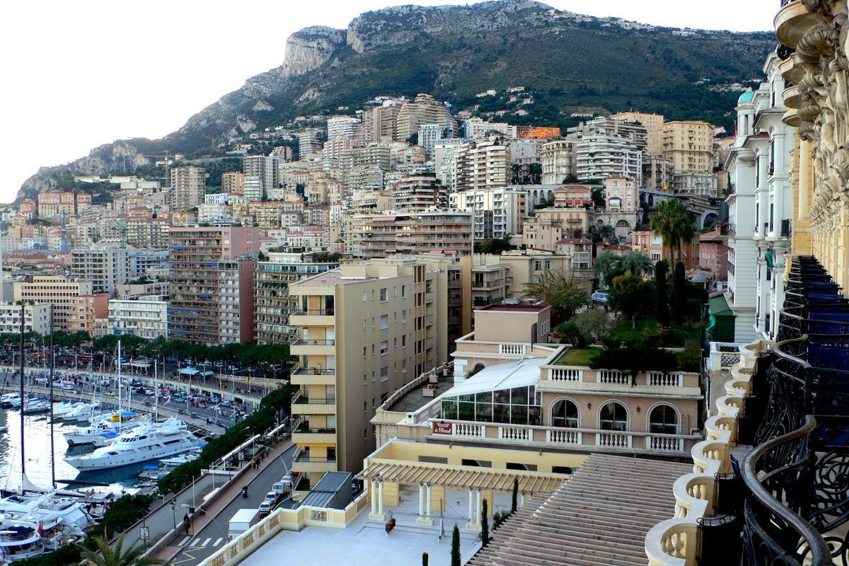 Monte Carlo and Port Hercule in Monaco, yachts moored below the hillside city
